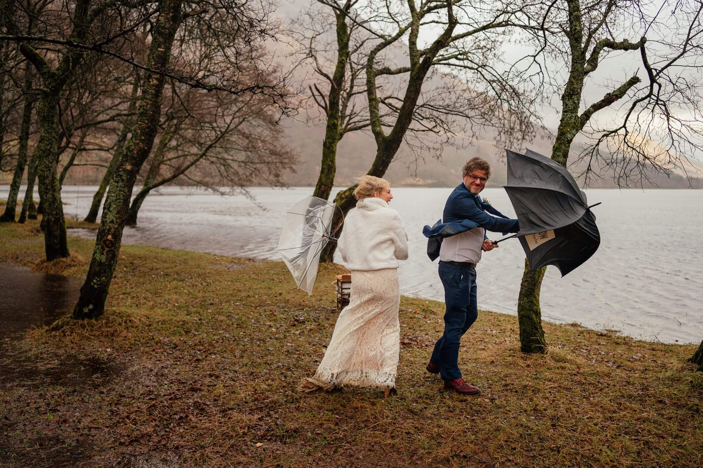 monachyle mhor elopement rain wedding bride groom at loch voil windy umbrellas