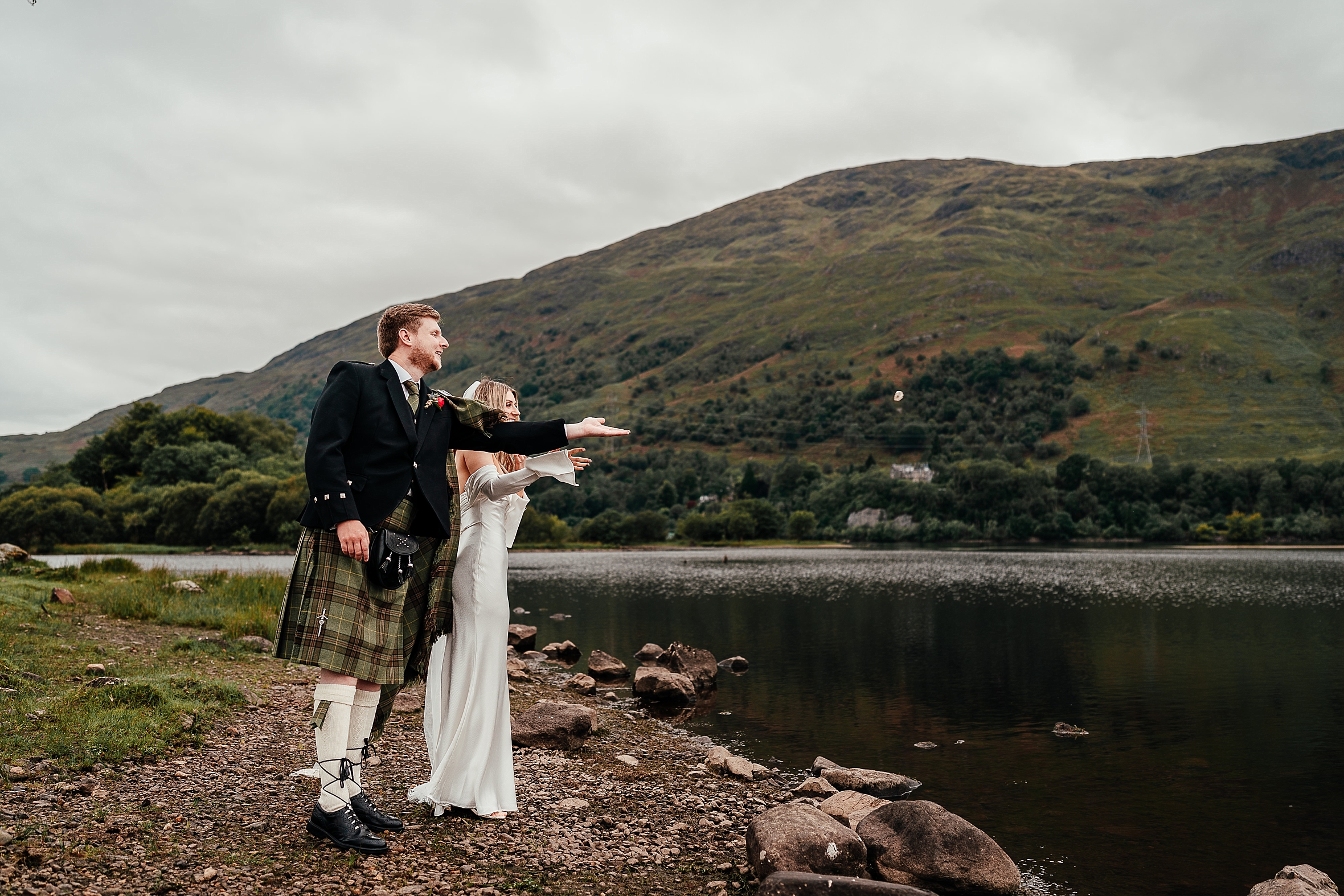 an oathing stone being thrown into a loch by a bride and groom as a wedding traditions scotland