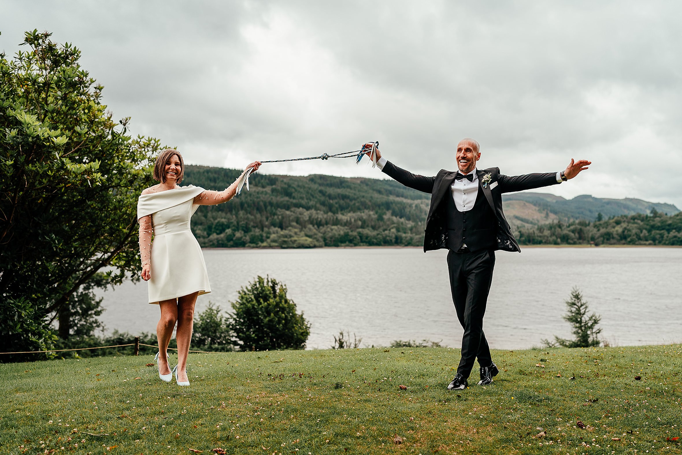 bride and groom handfast during scottish wedding ceremony in a wedding traditions scotland