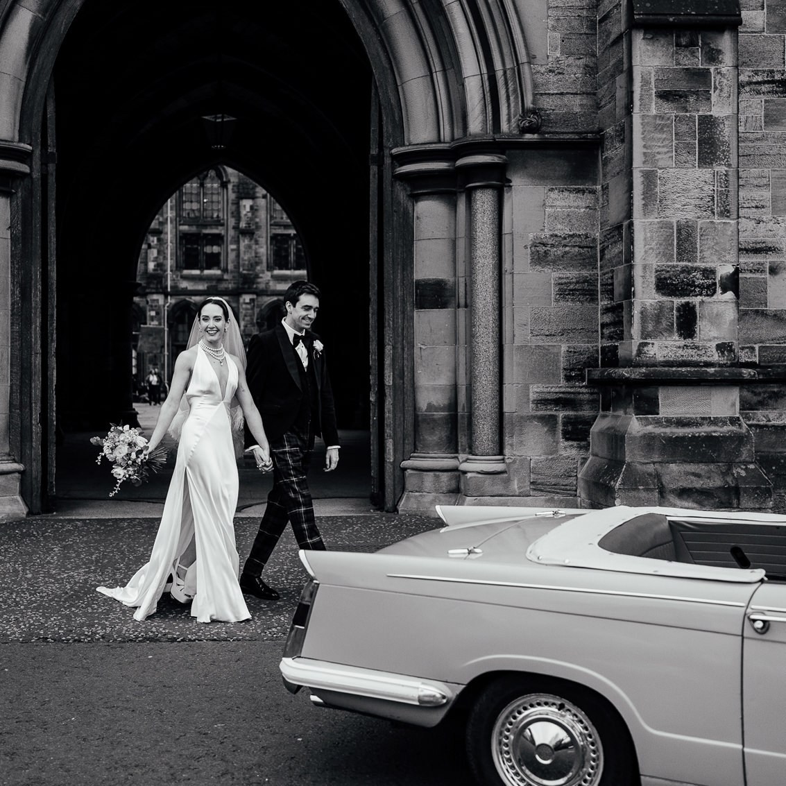 bride and groom smile as they exit their glasgow elopement with wee city weddings scotland all inclusive wedding packages
