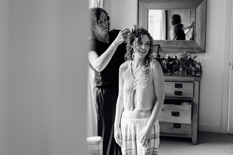 a bride has her hair and makeup done as part of an all inclusive elopement package in glasgow scotland
