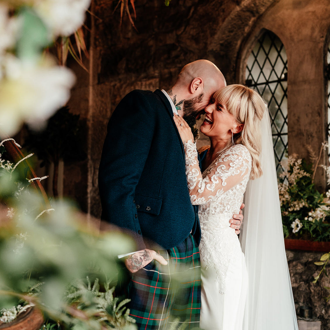 bride and groom kiss inside the bell tower at oran mor a west end city elopement venue in glasgow scotland